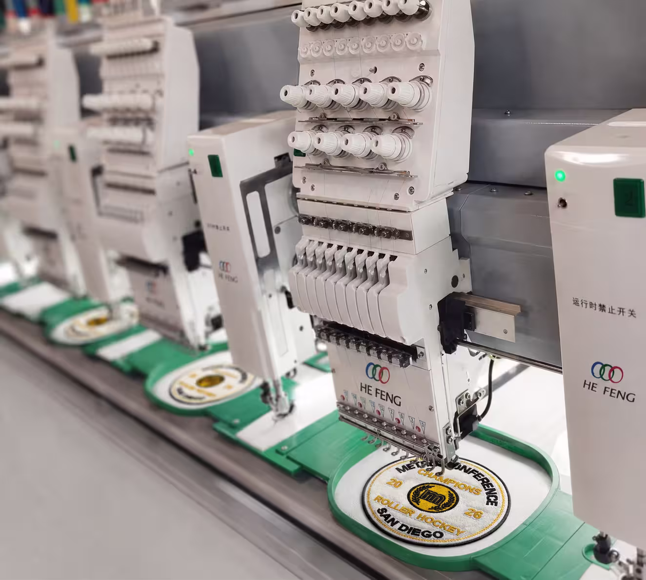 Chenille and appliqué championship patches running on a commercial multi-head Tajima embroidery machine